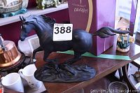 Side angle photo of Black Beauty porcelain horse figurine with detailed flowing mane, tail, and base.
