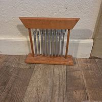 Front view of wooden table chime showing frame and metal rods