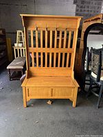 Full view of hall tree showing slatted back, hooks, bench base