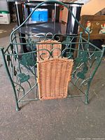 Full view of magazine rack front showing metal frame and wicker panels