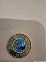 Reverse side showing colorized marine life design on bimetal coin
