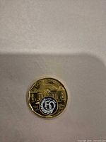 Reverse of coin showing 150th anniversary design and building motif