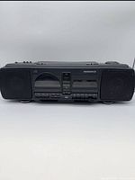 Front view of Magnavox boombox showing speakers, CD door, cassette decks and controls