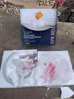 Opened packaging with glass shade, canopy, hardware in foam