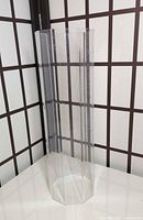 full view of clear octagonal acrylic riser standing upright