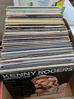 Stack of LPs in box, front record Kenny Rogers Greatest Hits