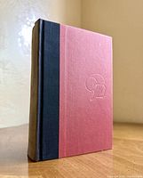 Front and spine angle showing quarter-cloth binding and embossed board
