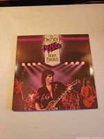 Front of gatefold sleeve featuring April Wine live imagery