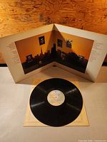 Gatefold jacket opened with vinyl record resting on inner sleeve
