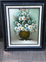 Front view of framed floral still life painting