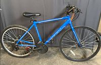 Full left-side view of the blue CCM Vector hybrid bike