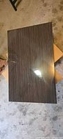 Rectangular dark brown striped laminate panel