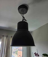 Pendant light installed on ceiling showing canopy, chain and shade