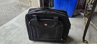 Front view of black SwissGear rolling briefcase