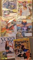 All six magazines laid out, four sealed in plastic, showing covers
