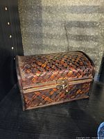 Closed woven rattan trinket box showing exterior texture and latch
