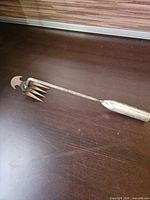 Full view of hand cultivator/weeder showing entire tool