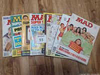 Front view of 7 overlapping Mad magazines showing variety of Super Special and regular issues