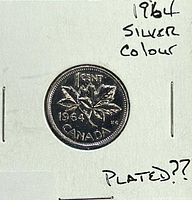 Full view of coin in holder showing reverse with maple leaves and 1964 date