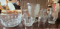 Entire lot showing pitcher, bowl, creamer, vase, three goblets