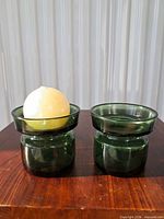Pair of Dansk green glass votive candle holders on table