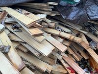 Pile of tongue-and-groove hardwood boards showing profile and unfinished surface
