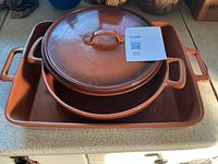 Dutch oven nested in casserole dish showing both items