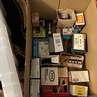 Overview of cardboard shipping box filled with multiple small boxes of fasteners