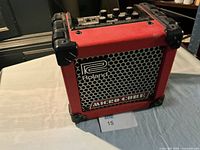 Front view of Roland Micro Cube amplifier showing grille and logo