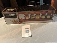 Front of boxed Winsome Wood teak spice rack showing product image and branding