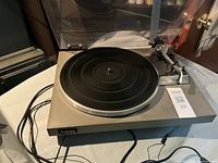 Top view of Technics turntable showing platter, tonearm, dust cover open