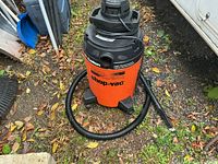 Front view of orange 10 gallon Shop-Vac with hose and wand