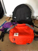 Photo showing all three Lowepro camera bags in black, purple, and orange: backpack, fanny pack, and messenger bag styles.