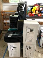 Photo showing the full lot arrangement: seven air purifiers including tower, tabletop, and HVAC types, and one infrared heater.