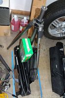 Basic overview of all included items in garage: Tomas V1701 tripod tray, Cullmann CT100 tripod, Tiltall tripod, some boxes and garage items.