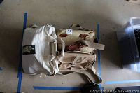 Photo of two camera bags and one computer bag arranged on the floor, showing front and top views.