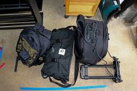 All three camera bags and collapsible hand truck shown from above on a garage floor.