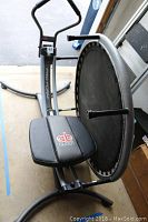 Photo of ProForm Ab Glider exercise machine featuring black padded seat with logo and handlebars.