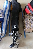 Top view of golf clubs in the black bag showing the club heads and bag label with lot number 54