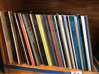 Shelf showing an assortment of Aperture magazines in various colors and sizes.