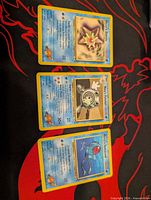 Front view of Misty’s Staryu, Misty’s Poliwhirl, and Misty’s Tentacool cards on playmat