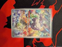 Front of Carbink rainbow holo card in sleeve