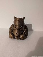 Front view of bronze-brown Snorlax Buddha figurine