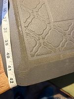 close-up of mat corner with tape measure showing 40-42 inch length
