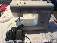 Kenmore sewing machine with foot pedal and power cord visible