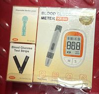 Shrink-wrapped KE-B6 meter kit showing meter box, lancets box, and test strips box
