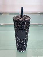 Full view of tumbler with straw standing upright