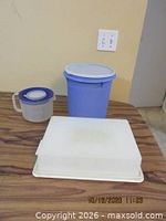 Blue cylindrical container, translucent handled pitcher, rectangular cake taker