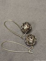 Both earrings showing spherical filigree beads and kidney wires
