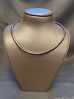 Full view of necklace on stand